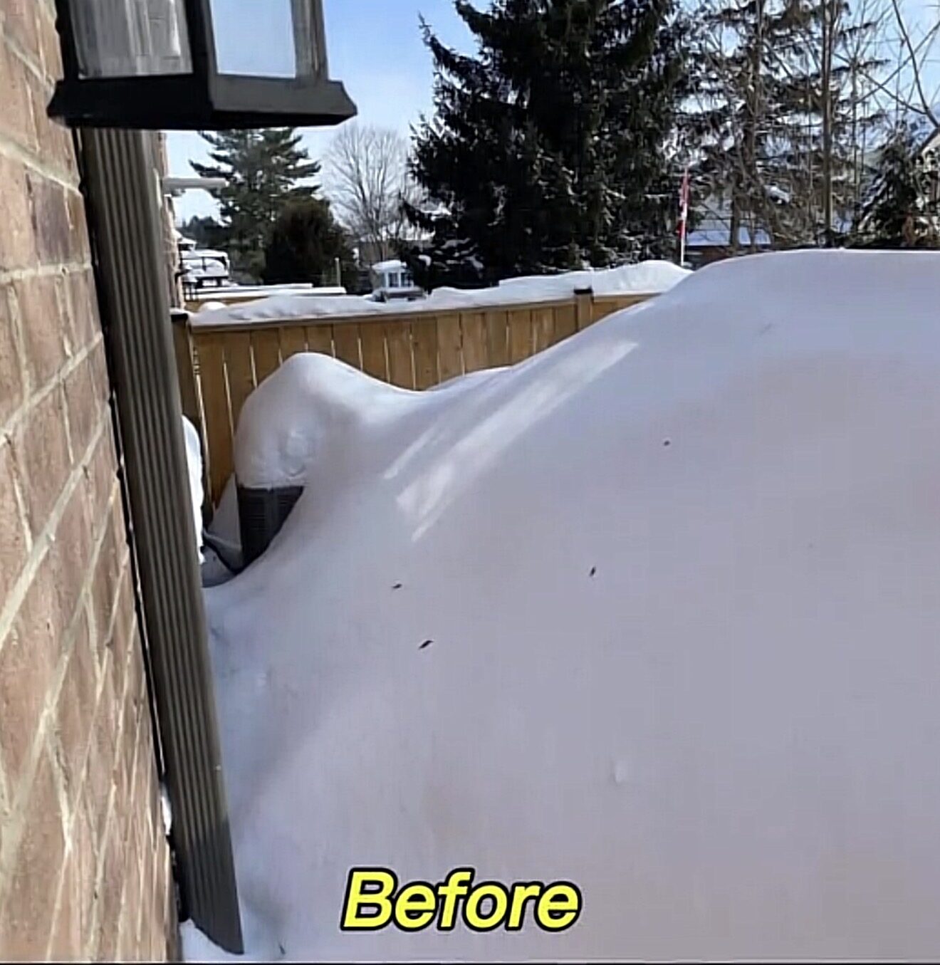 Deep snow beside a home before clearing